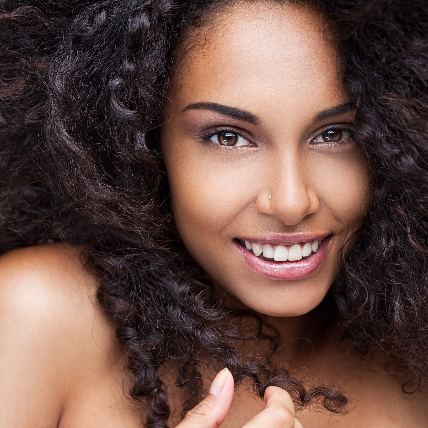 Facial Treatments - close up of African American woman smiling