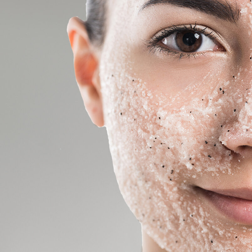 close up of woman with a scrub on her face